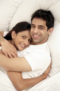 Couple hugging in bed