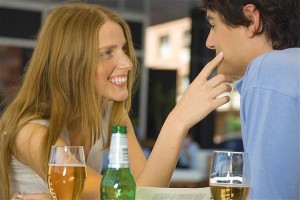 Woman flirting over drinks