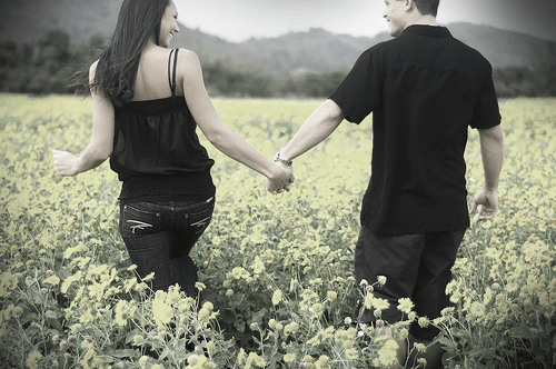 Couple walking through a field