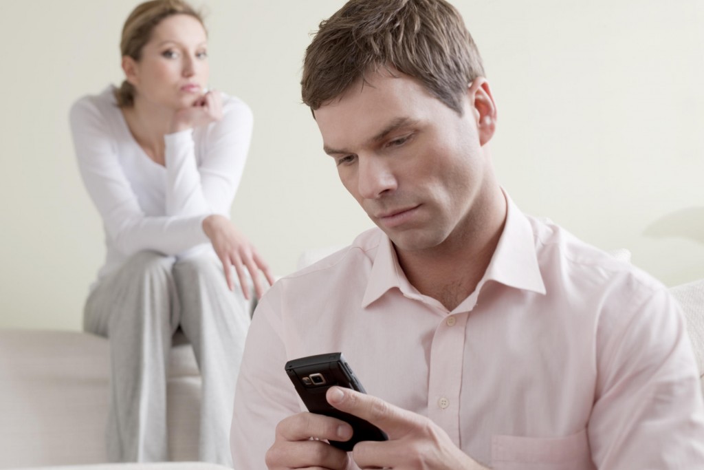 Jealous woman watching man text