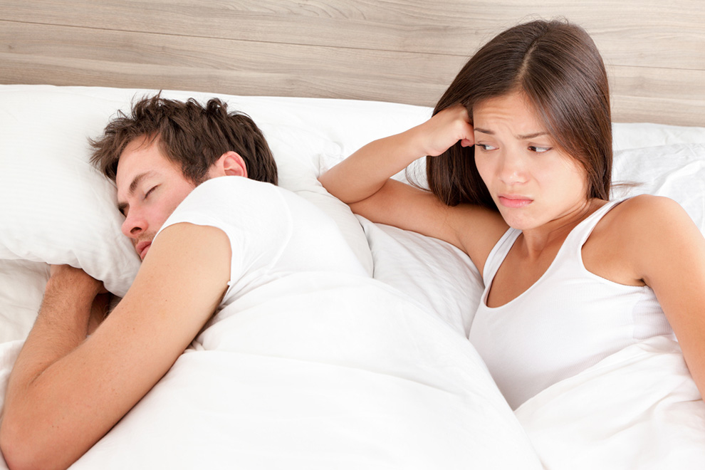 Woman not liking man sleeping in bed
