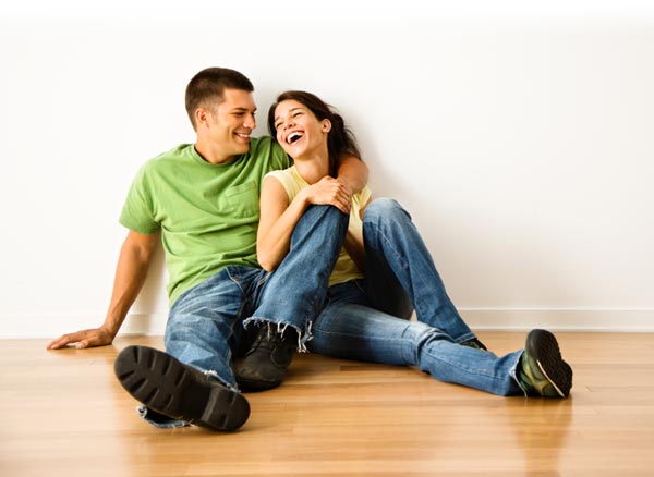 Couple sitting on the floor laughing