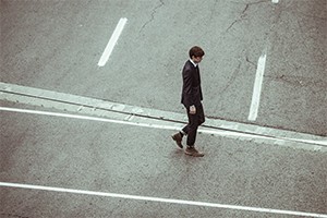 Man walking down empty street alone.