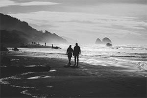 Couple walking on the beach.