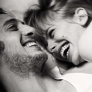 Couple laughing in bed together