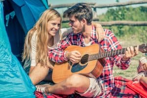 man plays guitar for woman