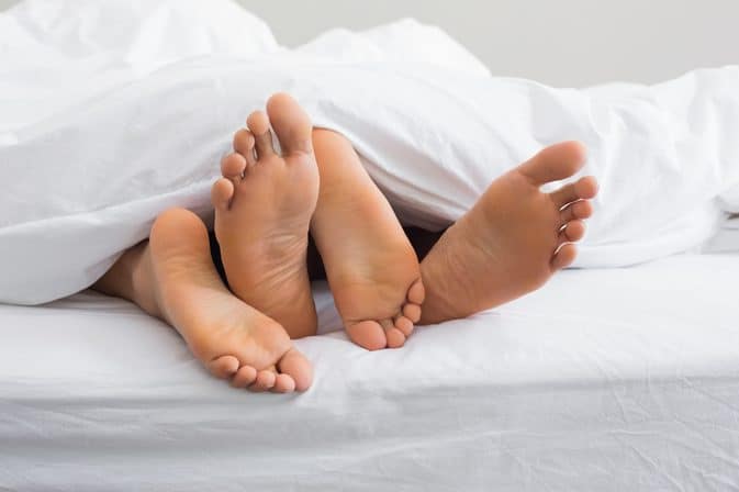 couple's feet in bed
